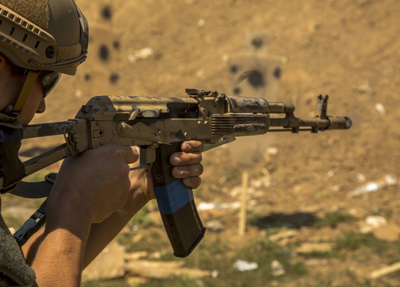 Ukrainian soldier aiming AK-47 at the target