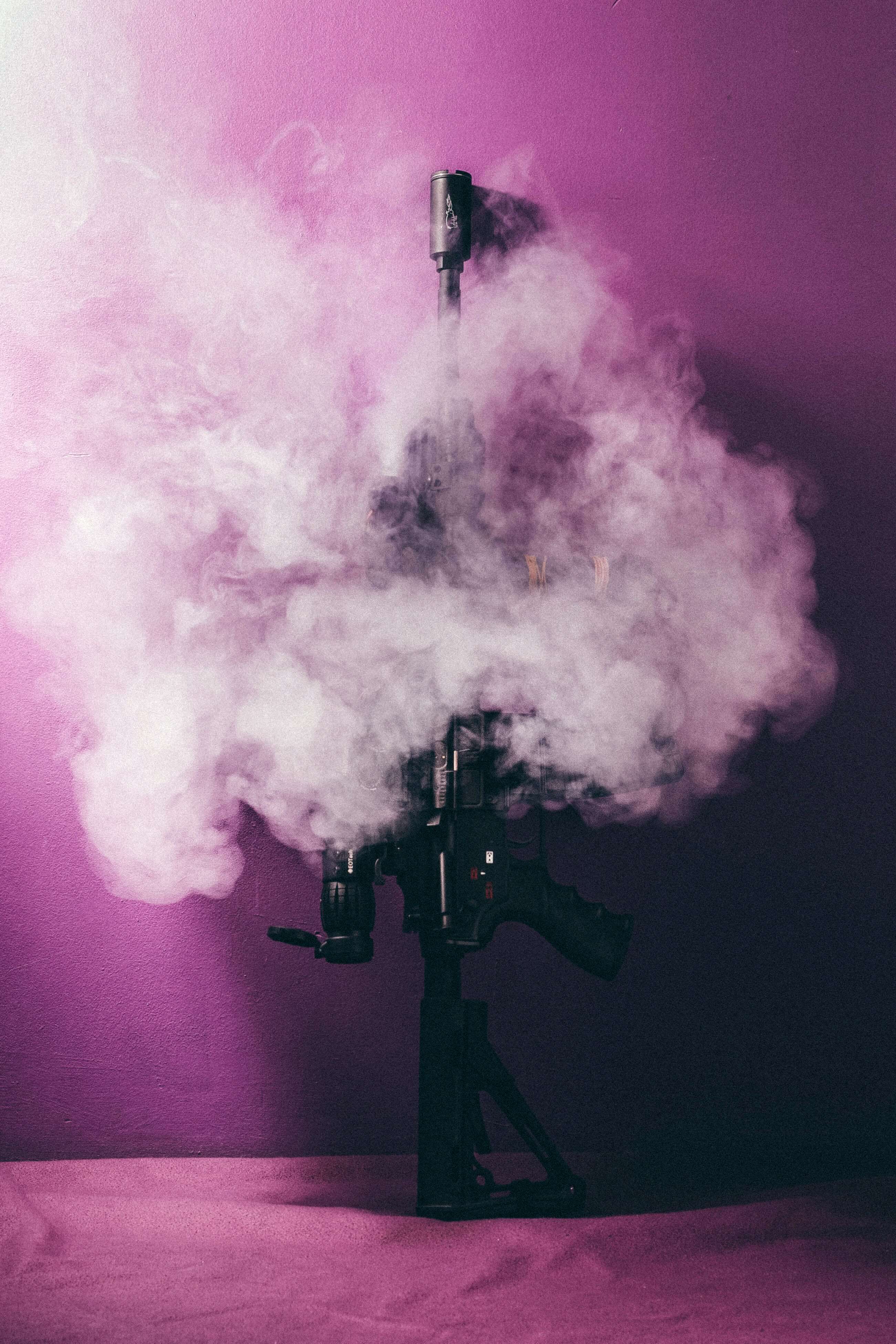 smoking rifle in pink light